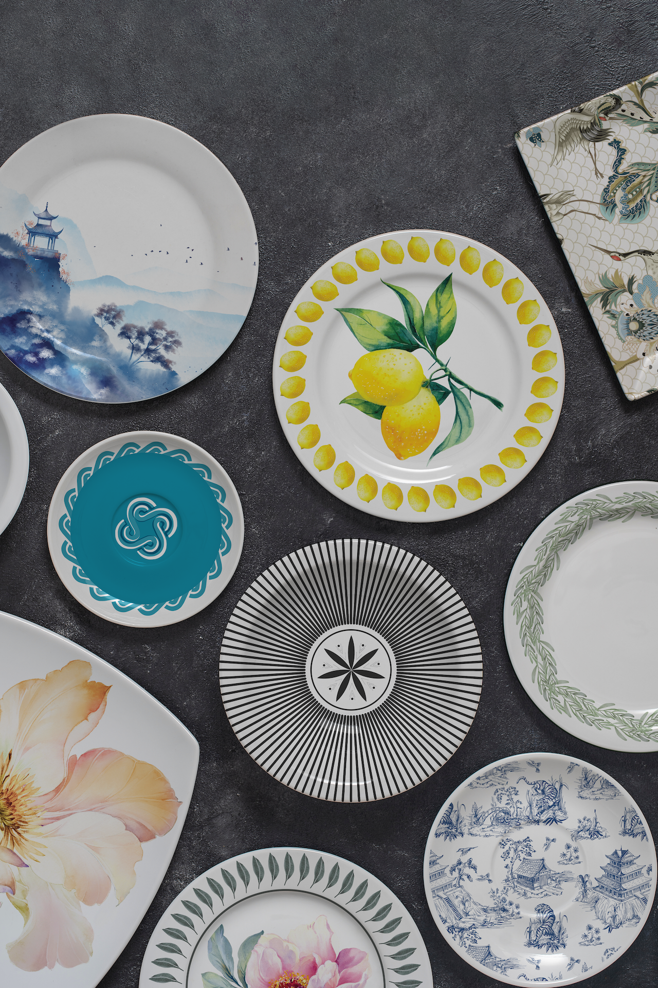 A variety of ceramic dishes with different printed patterns on a table.