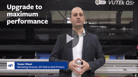A printer image of the VUTEk Q5r, with Tomer Ohavi, EFI Marketing director in front of the printer