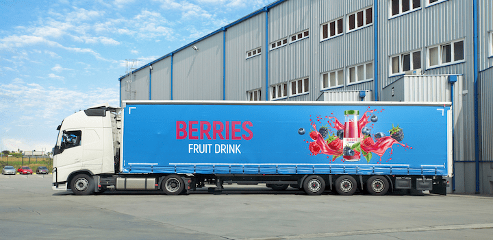 Truck side curtain advertising berries.