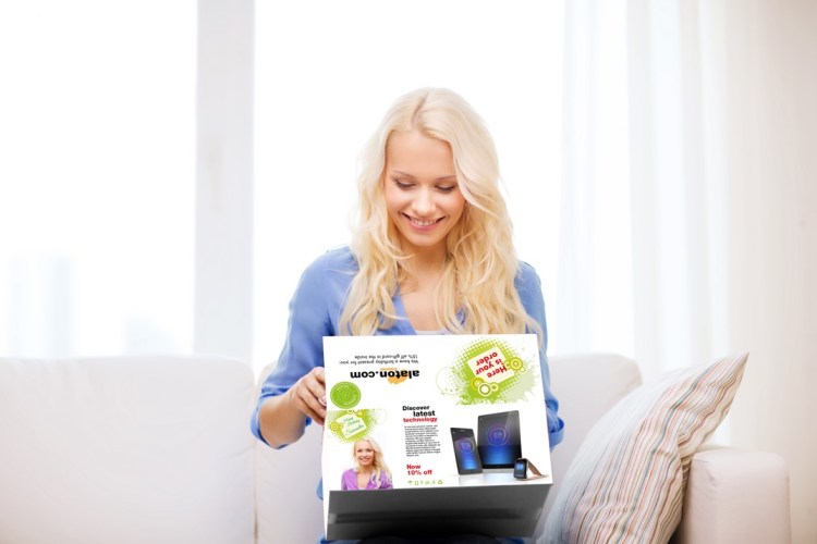 Woman sitting on a couch and opening a eCommerce box.
