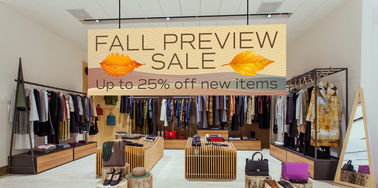 Hanging sign ini a retail store promoting a fall preview sale.